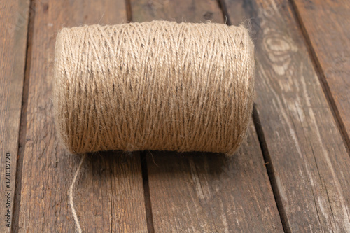 A roll of brown coir rope on wooden backgroud. Used in gardening