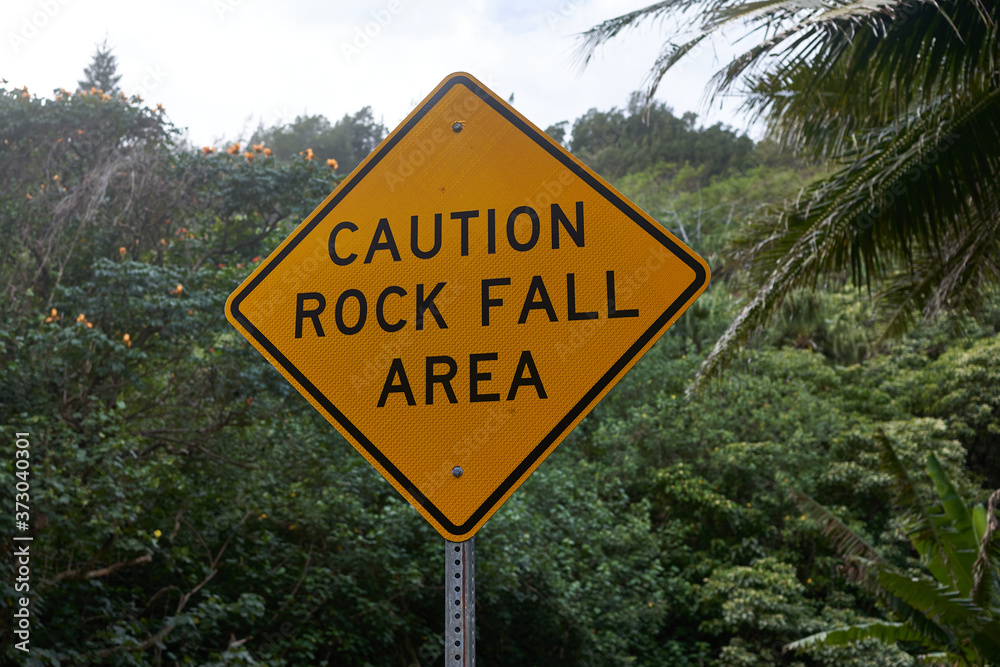 Rock fall area warning sign in a rural area on a tropical island.