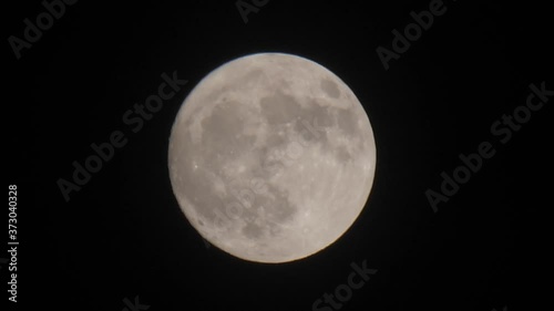 creepy cloud moving in full moon photo