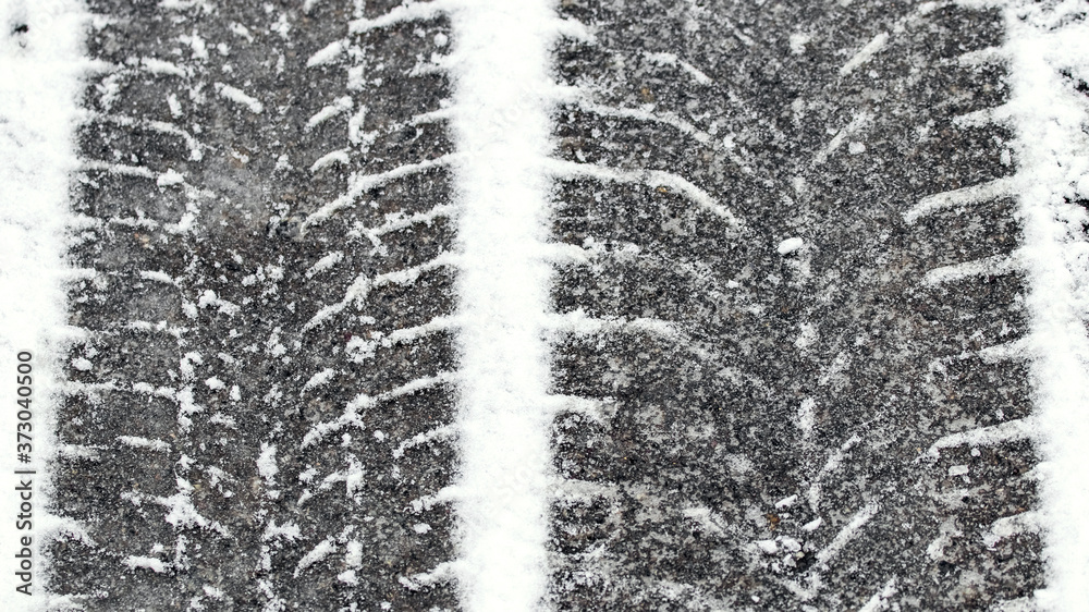 Traces of car tires in the snow, slippery road Traces of car tires in the snow, slippery road