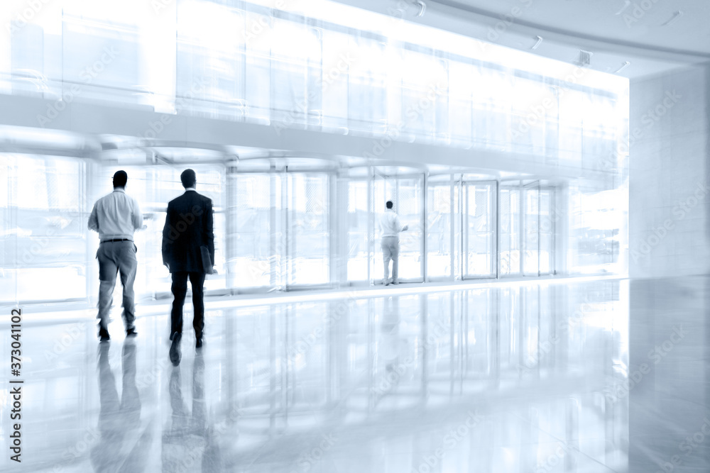 group of people in the lobby business center and blue tonality group of people in the lobby business center and blue tonality