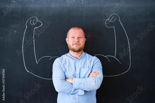 Successful self confident businessman with fake muscles made of chalk.
