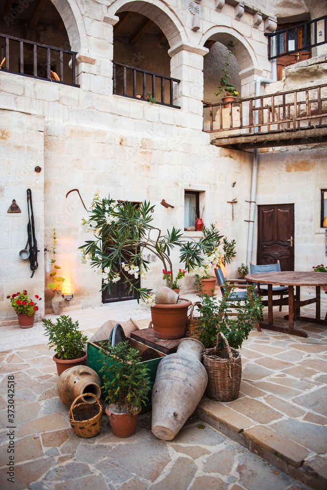 Fototapeta premium Turkish courtyard with green plants and old pitchers