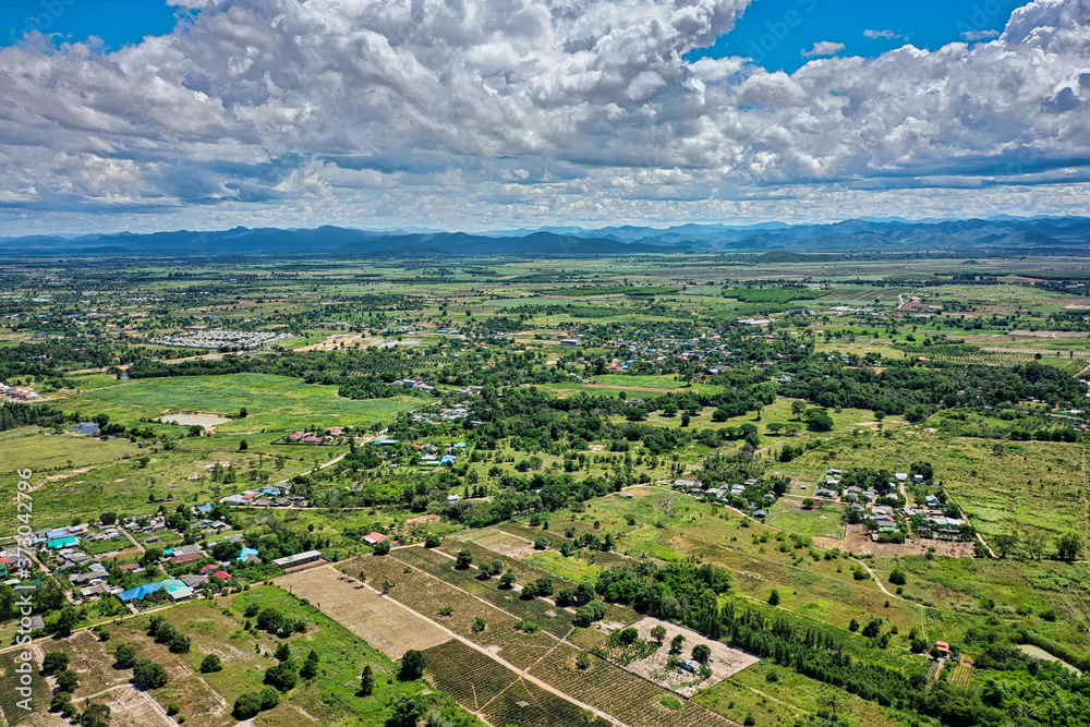 This unique photo shows the landscape of Hua Hin in Thailand and in the background the green mountains with a slightly cloudy blue sky