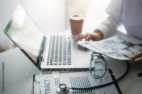 Doctor planning Treatment monograph,with clipboard and Laptop.
