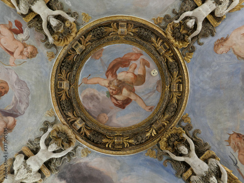 Low angle shot of renaissance paintings and sculptures on a ceiling photo