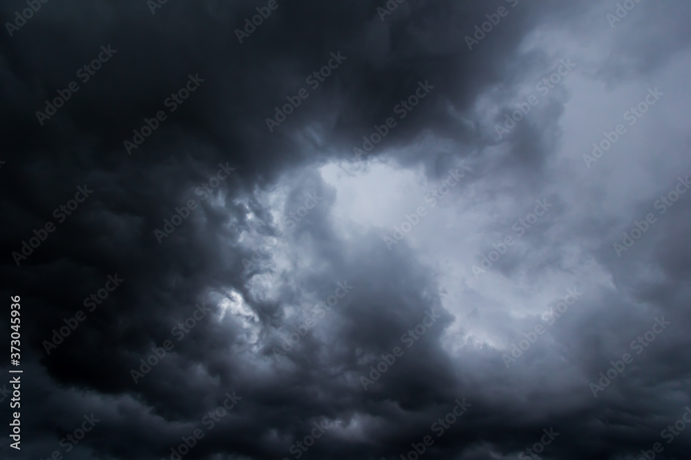 The dark sky had clouds gathered to the left and a strong storm before it rained.Bad weather sky.