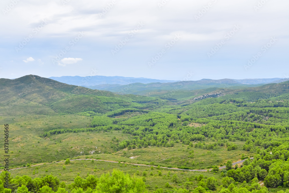 Landscape shot of a wide area with hills and vegetation at the countryside