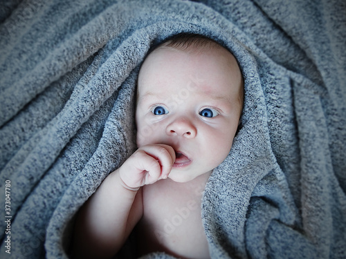 Newborn in warm soft blanket.