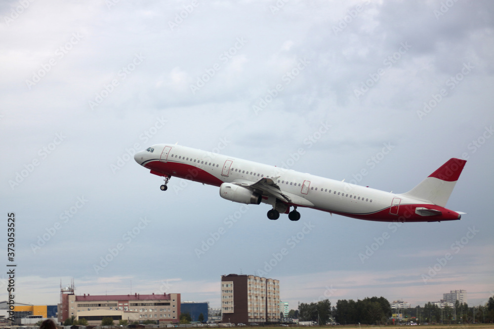 Passenger plane takes off from the airport runway. Side-view of aircraft Passenger plane takes off from the airport runway. Side-view of aircraft