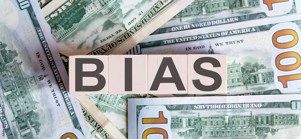 Obraz premium Concept words BIAS on wooden blocks on a beautiful background from dollar bills.