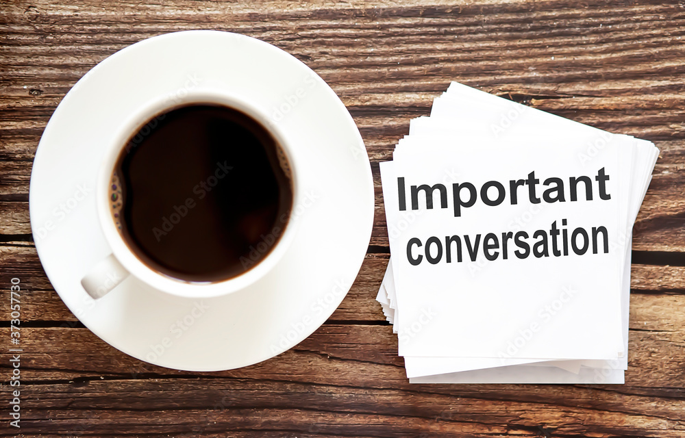 Business IMPORTANT CONVERSATION . White stickers with text on the wooden background with coffee Business IMPORTANT CONVERSATION . White stickers with text on the wooden background with coffee