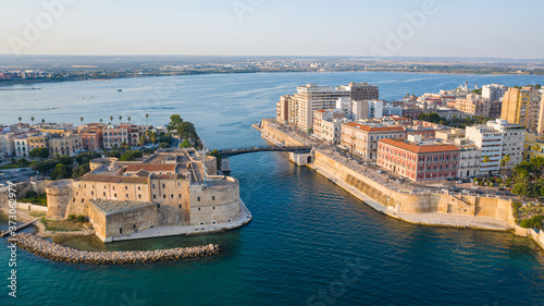 Beautiful panoramic aerial view photo from flying drone on Old medieval Aragonese Castle on sea channel, old town of Taranto city, Puglia (Apulia), Italy (Series) photo