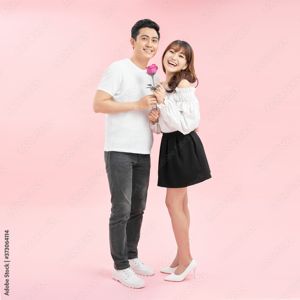 Young man presenting a flower to his girlfriend Young man presenting a flower to his girlfriend