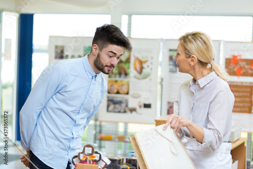 surprised young male customer looking into bag at checkout