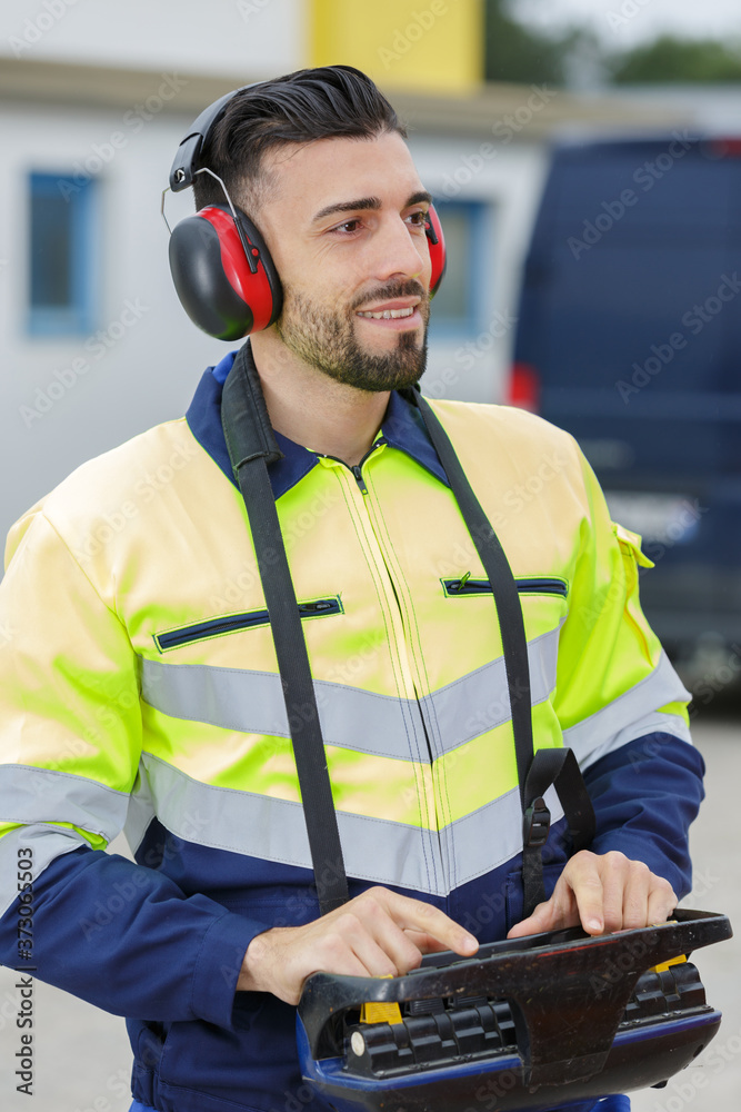 worker using remote control for crane