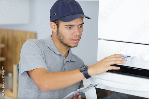 portrait of a young worker standing in kitchen