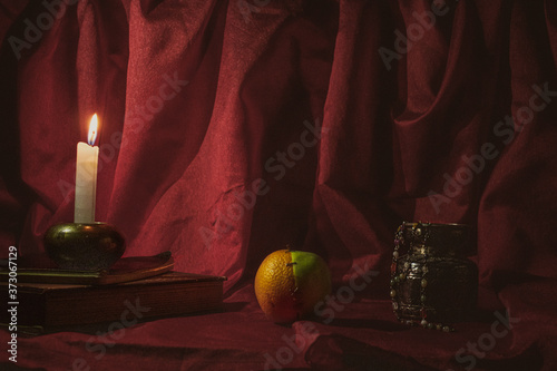 Still life with candle and fruits