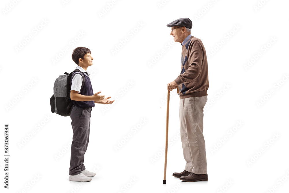 Full length profile shot of a schoolboy and a grandfather having a conversation Full length profile shot of a schoolboy and a grandfather having a conversation