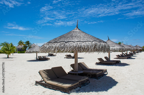 Fototapeta Naklejka Na Ścianę i Meble -  Tropical beach with sunbeds at the island in Maldives