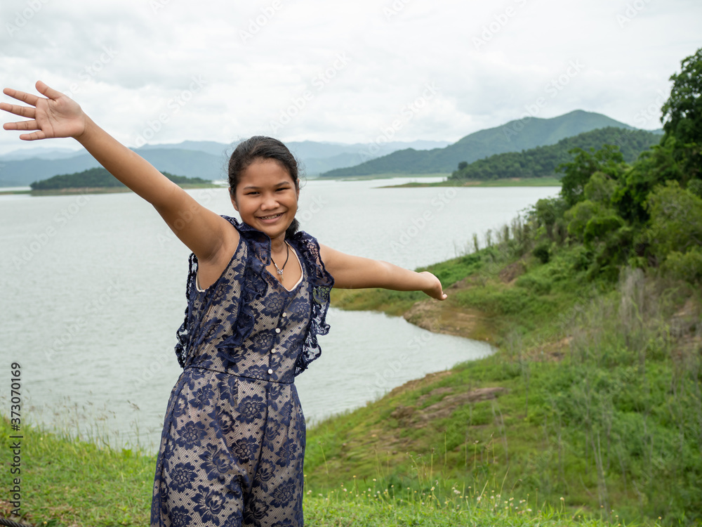 Asian woman Stand on the reservoir background at tourist places in thailand Asian woman Stand on the reservoir background at tourist places in thailand