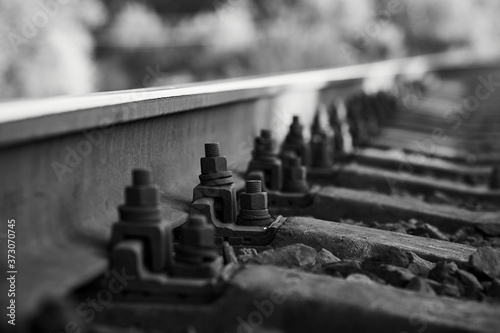 Black and white photo of a close-up view of rails