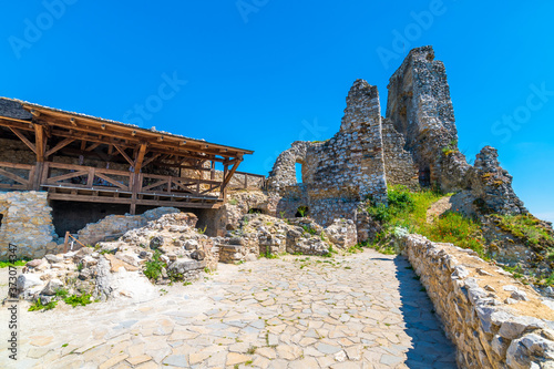 The old ruins of castle Cachtice    achtice in local speak . Ruined castle on top of hill at Slovakia. Famous and mysterious place known from legend of blood lady Bathory. Summer day  panorama view.