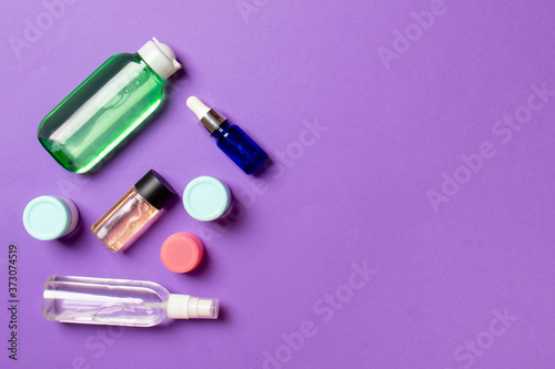 Cosmetics SPA branding mock-up  top view with copy space. set of tubes and jars of cream flat lay on colored background