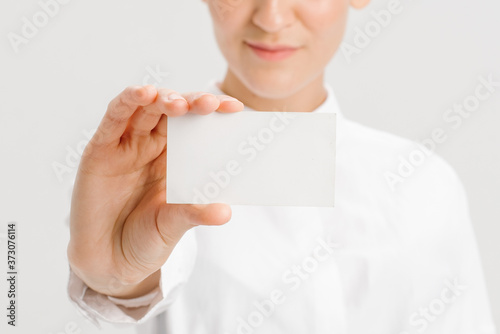  close-up portrait of a young businesswoman with Blank Business Card © Yuliya
