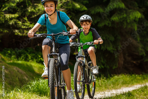 Healthy lifestyle - teenage girl and boy cycling 