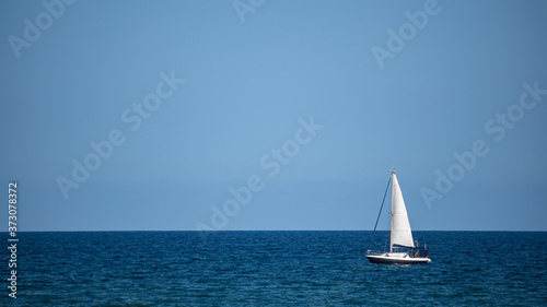 Small sailboat in the middle of the ocean
