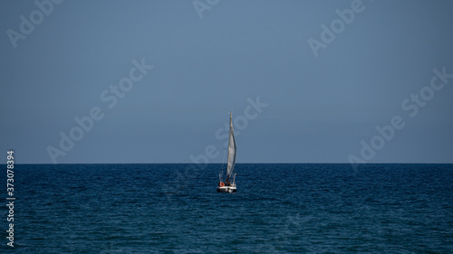 Small sailboat in the middle of the ocean