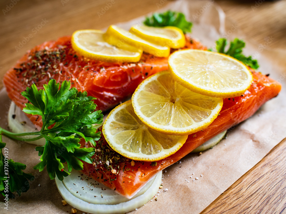 Fresh raw salmon steaks on baking paper
Fresh raw salmon steaks on baking paper