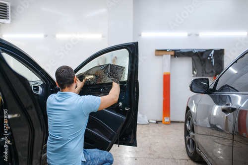 Specialist installs wetted car tinting, tuning photo