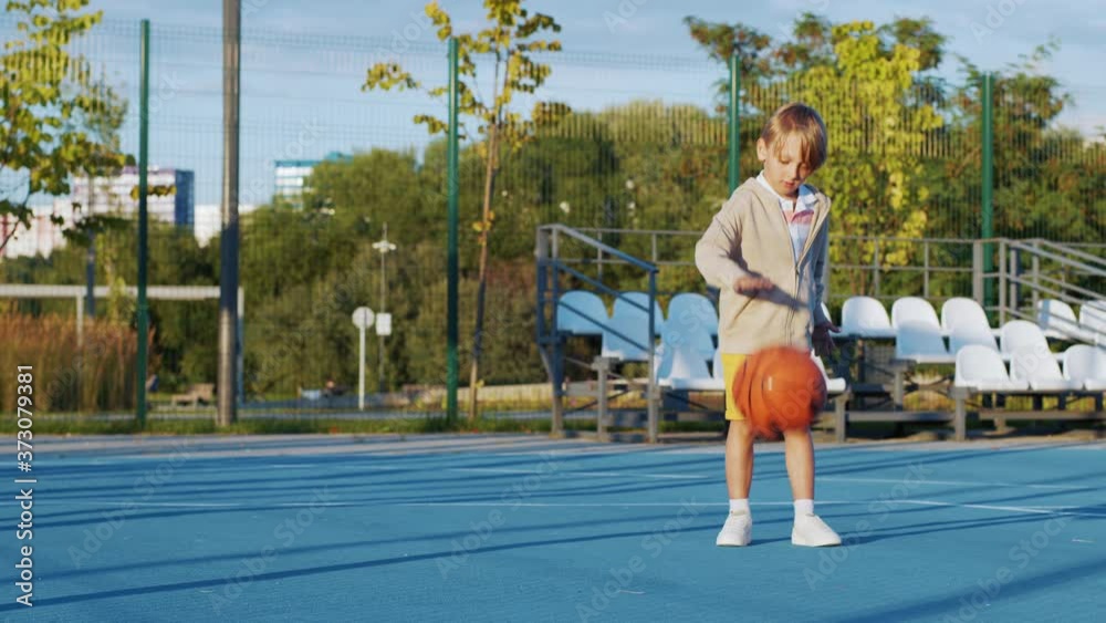 Little boy playing basketball on the street Little boy playing basketball on the street