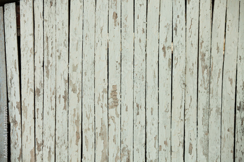 Vintage white wood background texture with knots and nail holes. Old painted wood wall. White abstract background. Vintage wooden dark horizontal boards. Front view with copy space