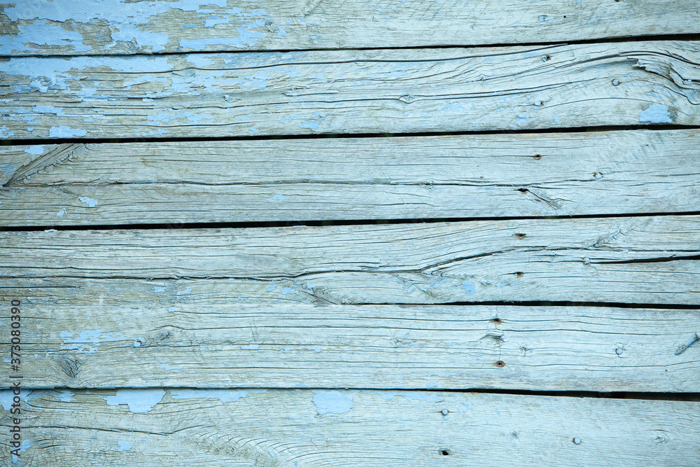 Obraz premium Vintage blue wood background texture with knots and nail holes. Old painted wood wall. Blue abstract background. Vintage wooden dark horizontal boards. Front view with copy space