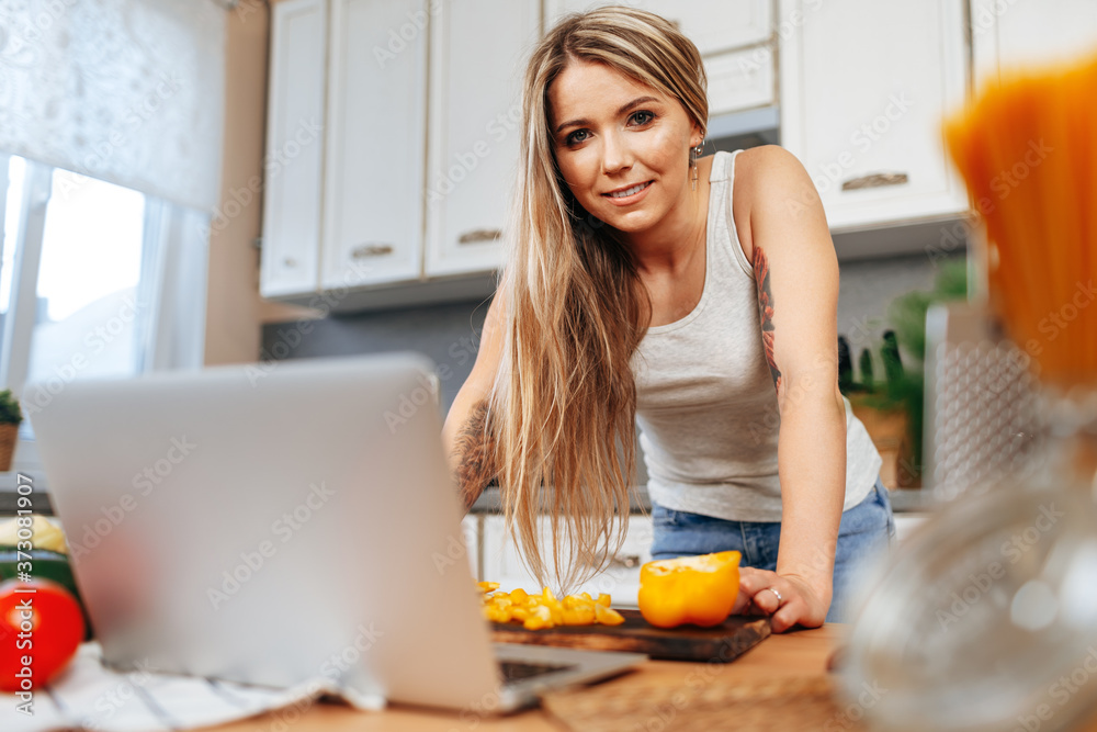 Young pretty woman cooking something in her kitchen Young pretty woman cooking something in her kitchen