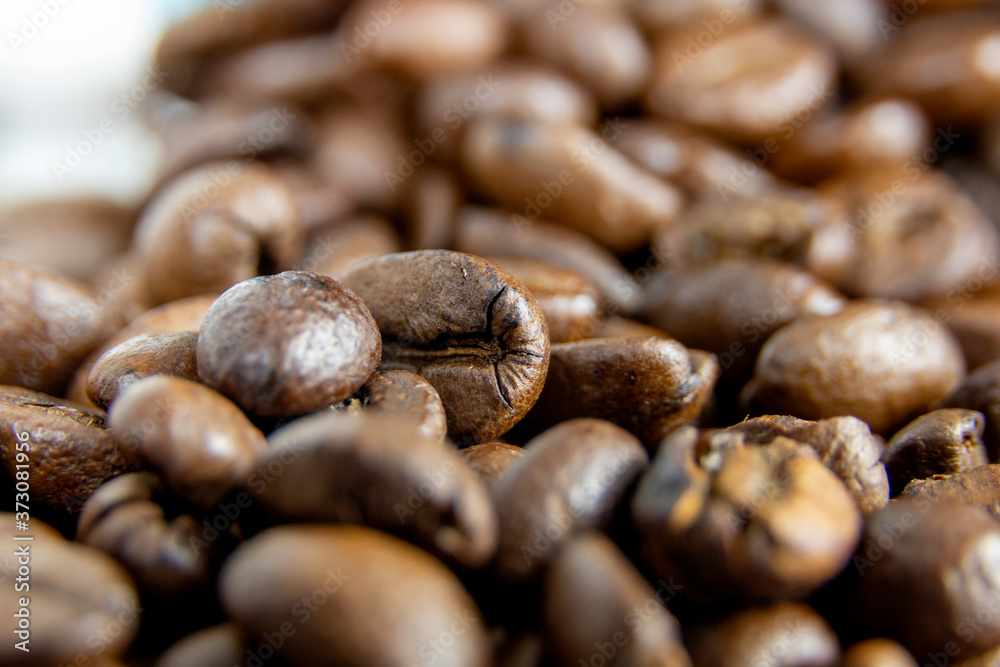 Fototapeta premium Detail of brown coffee beans on white background