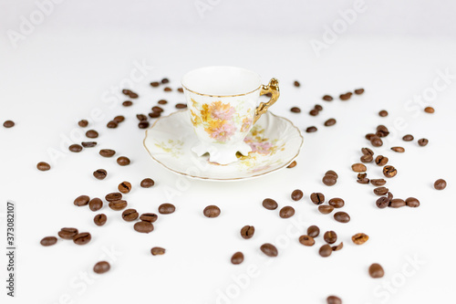 Cup of coffee or porcelain tea on white background with coffee beans