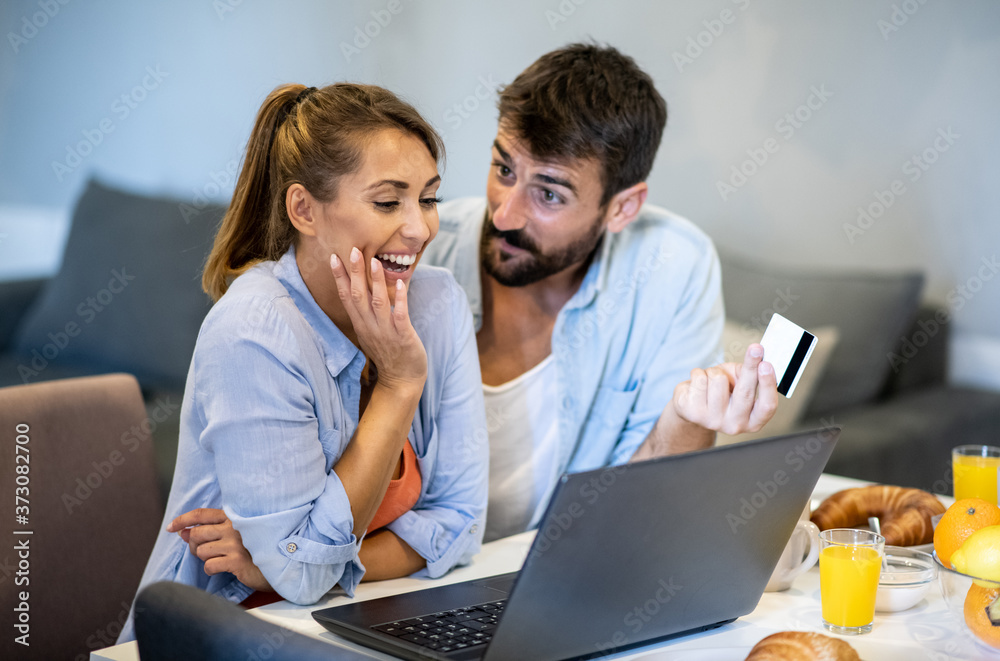 Husband and wife together buy online with a credit card, buy new things for a new apartment, talking Husband and wife together buy online with a credit card, buy new things for a new apartment, talking