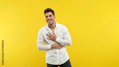 Young handsome man laughing and having fun, being relaxed and cheerful, feels confident and successful