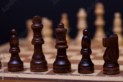 A game of chess, the beginning of a chess game two sides opposite each other.