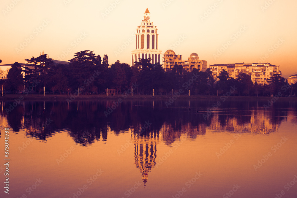 Obraz premium Adjara, casino Batumi, clock tower, embankment, sunset, reflection in the pond