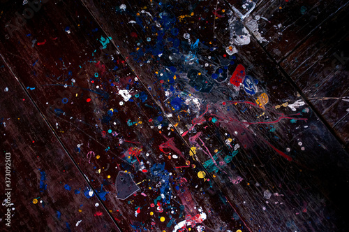 Drops of oil paint on a wooden background for a dark background.