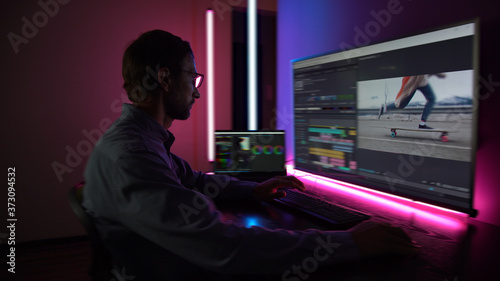 The man makes video editing. Video production. Color Correction. Sound editing. Film making. The work of a freelancer. Equipment filmmaking. Create videos. Program for video editing.	
