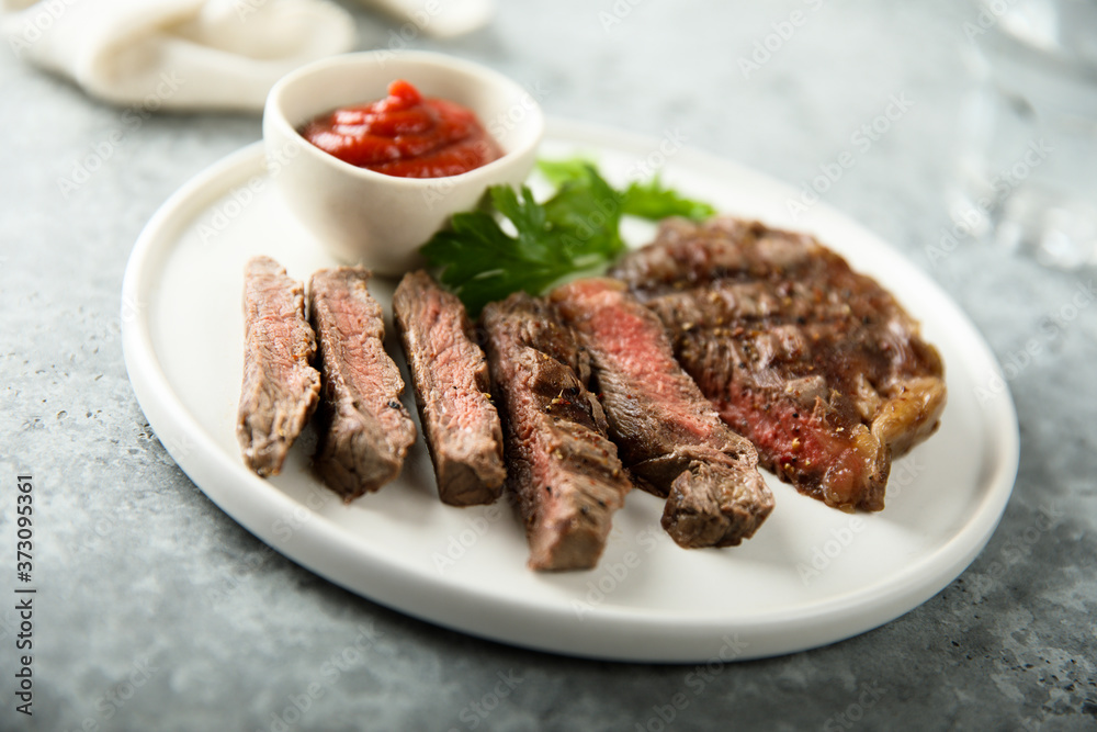 Grilled beef steak with tomato sauce