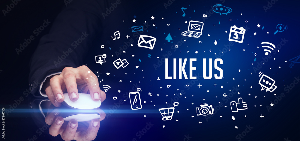 hand holding wireless peripheral with LIKE US inscription, social media concept hand holding wireless peripheral with LIKE US inscription, social media concept