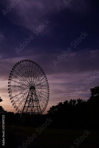 Ferris wheel after sunset at Kasai Rinkai koen, Tokyo, Japan. Purple and blue sky is beautiful. © dokosola