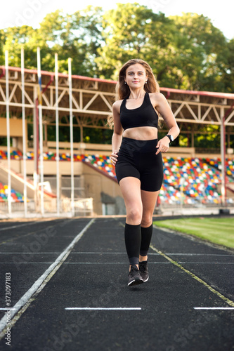young, athletic girl running on the track